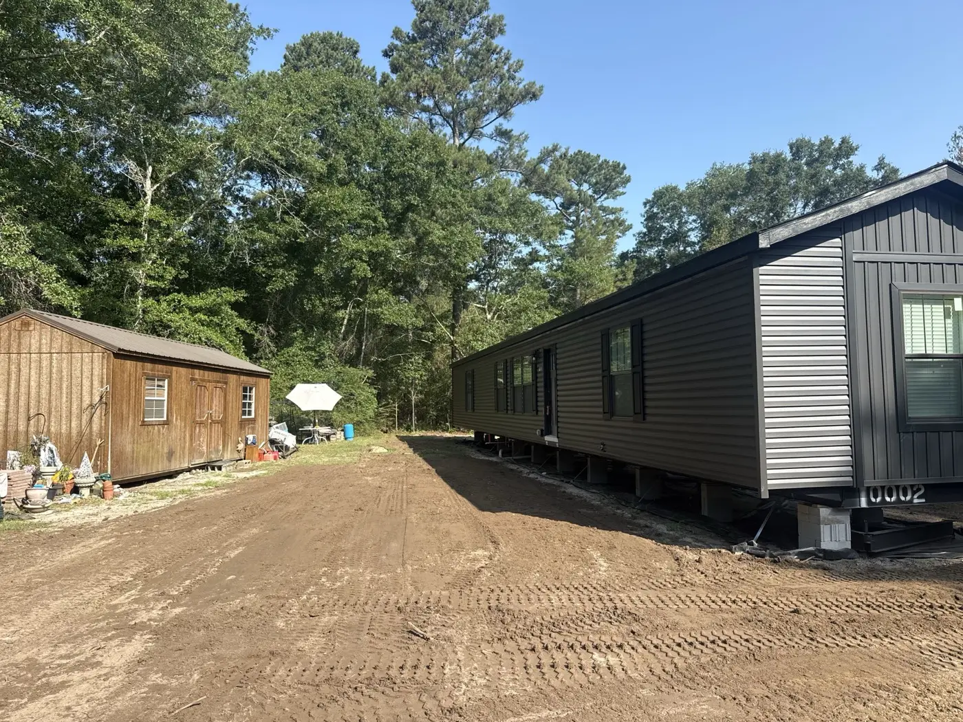 New manufactured home set on a freshly prepped lot and drive
